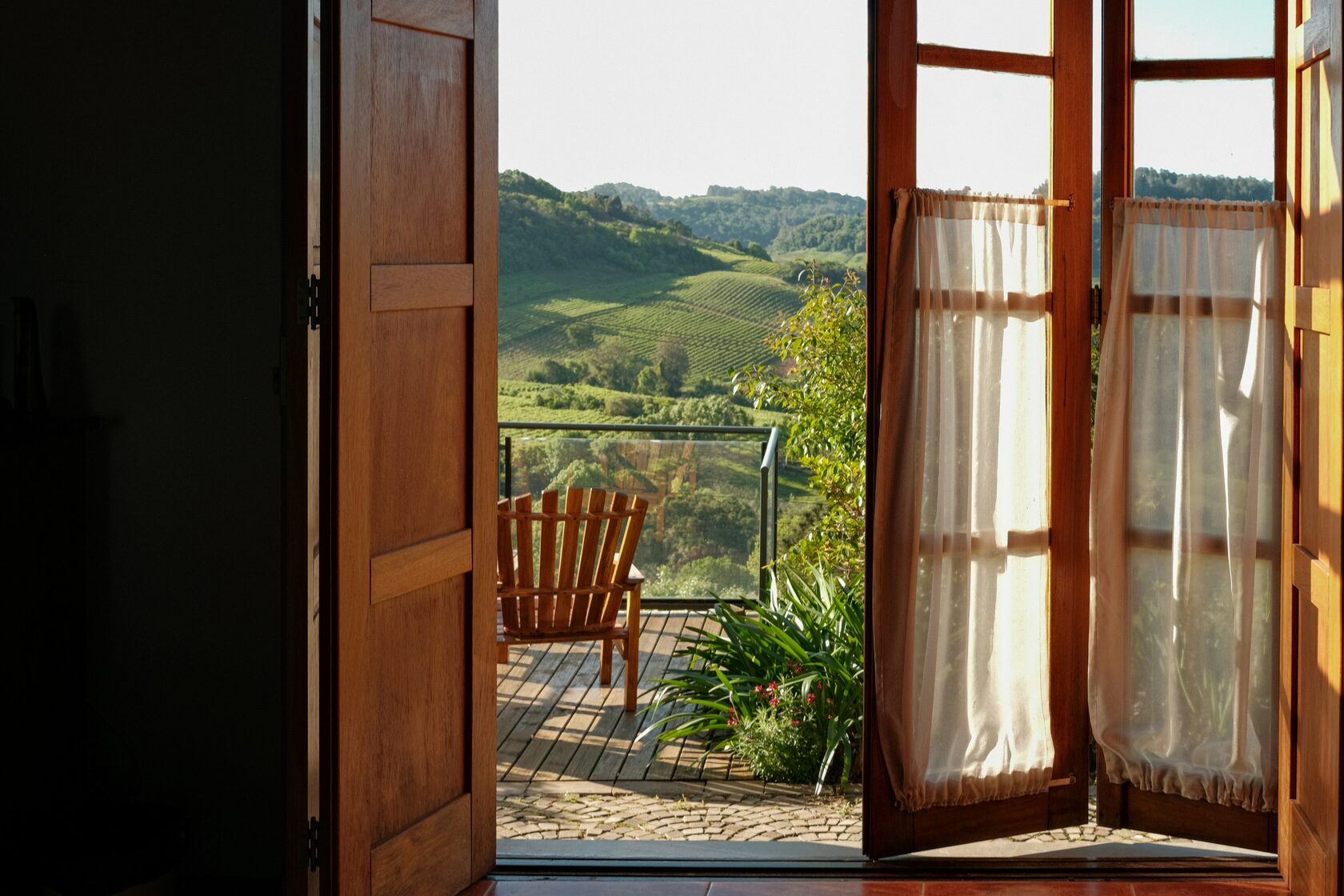 Boutique hotel room with view of Tuscan hills at sunset