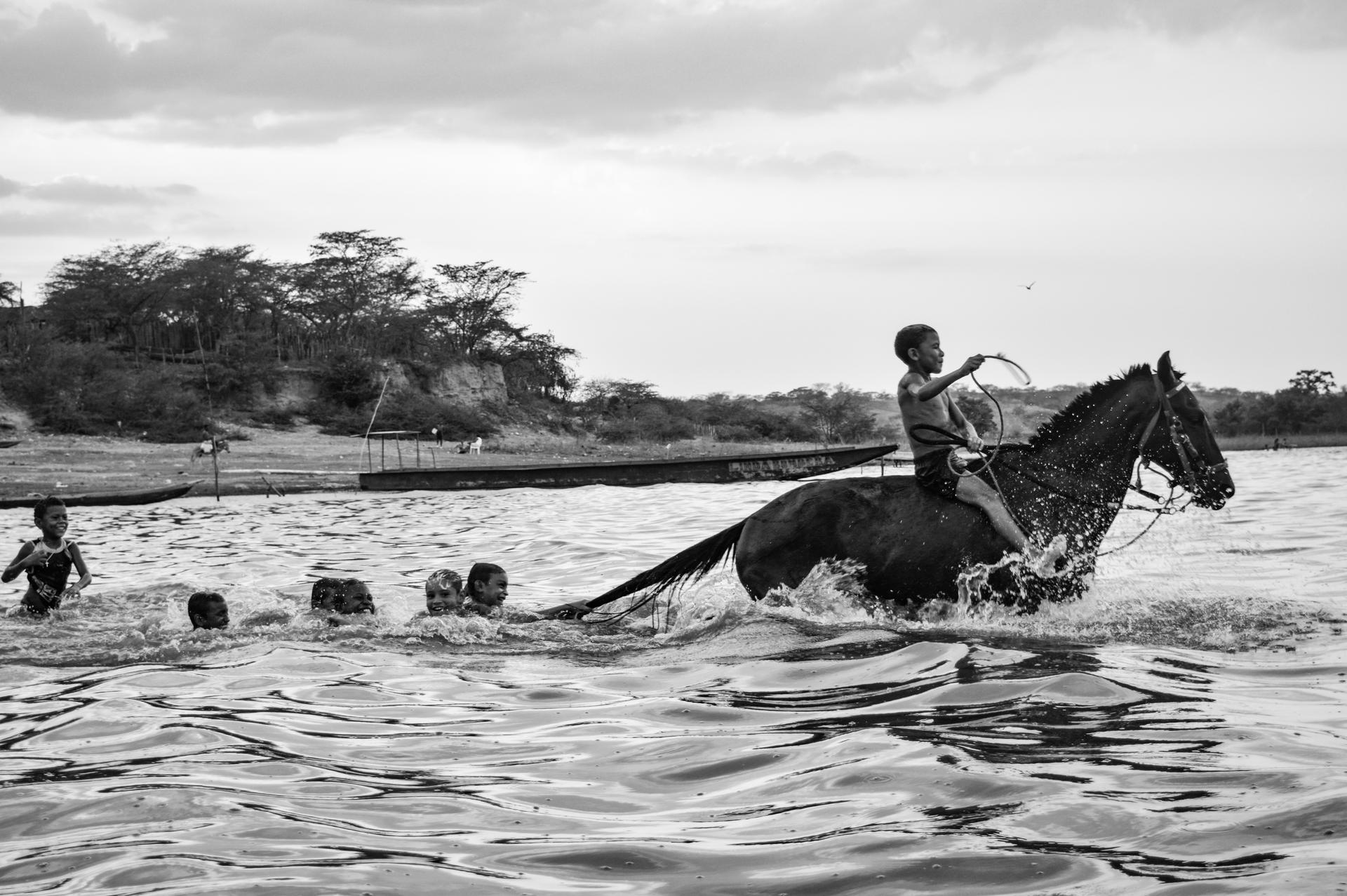 Colombia | Linda Esperanza Aragón. Children play in the water at the Zapaiana wetlands while adults fish and carry out daily routines nearby.