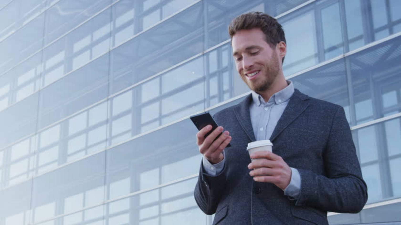 Man with Phone. Businessman with Phone. Man with Cell Phone. Man in Suit holding mobile Phone.