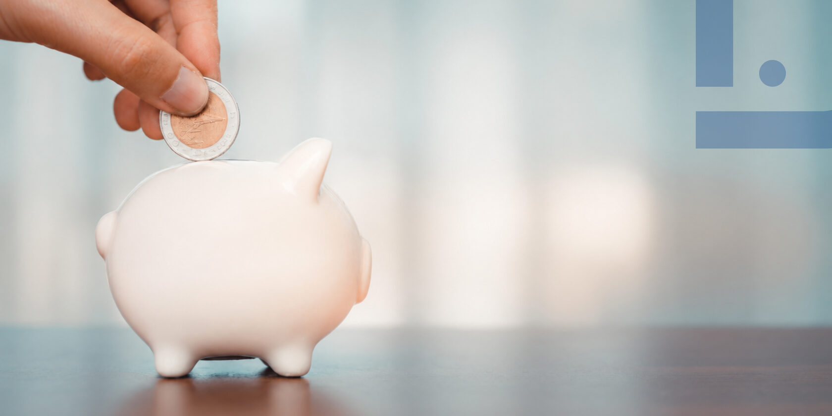Coin placed into white piggy bank — tax changes and VAT increase in Moldova from 2027