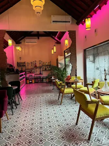 Colorful seating and vibrant pink lighting at Misha Shisha Ubud, a comfortable workspace-meets-lounge for digital nomads seeking the best shisha lounge in Bali.