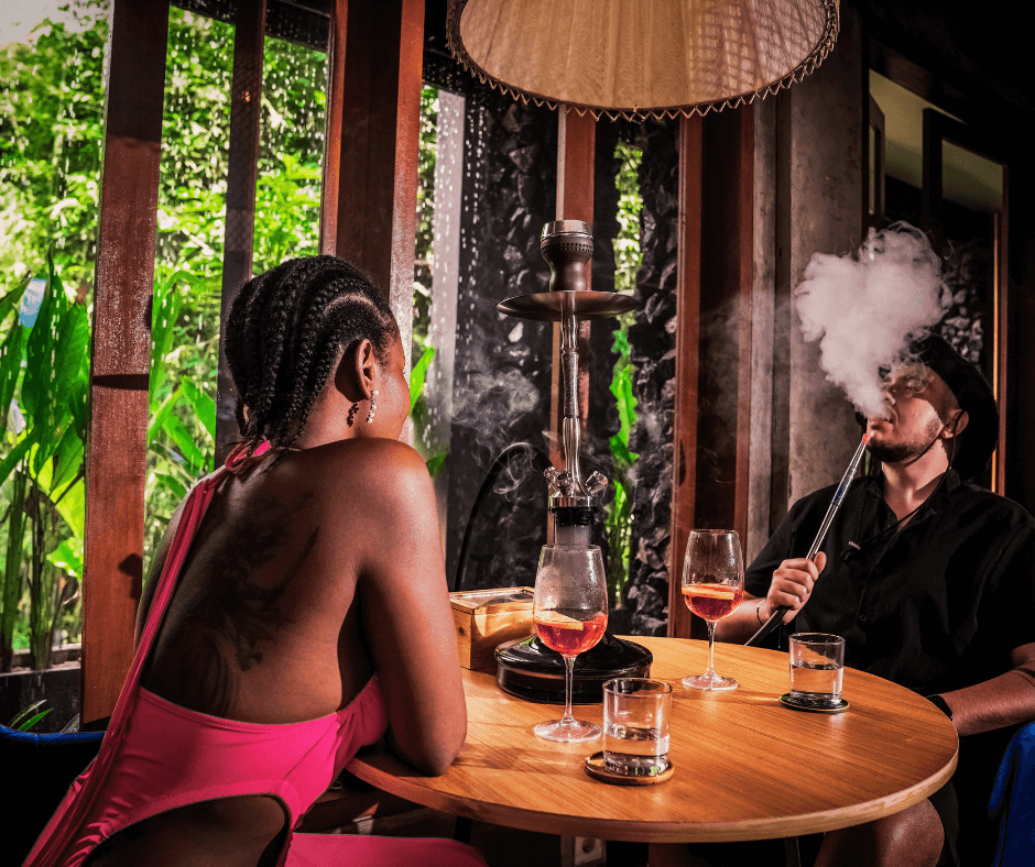 a man enjoying hookah in a lounge.