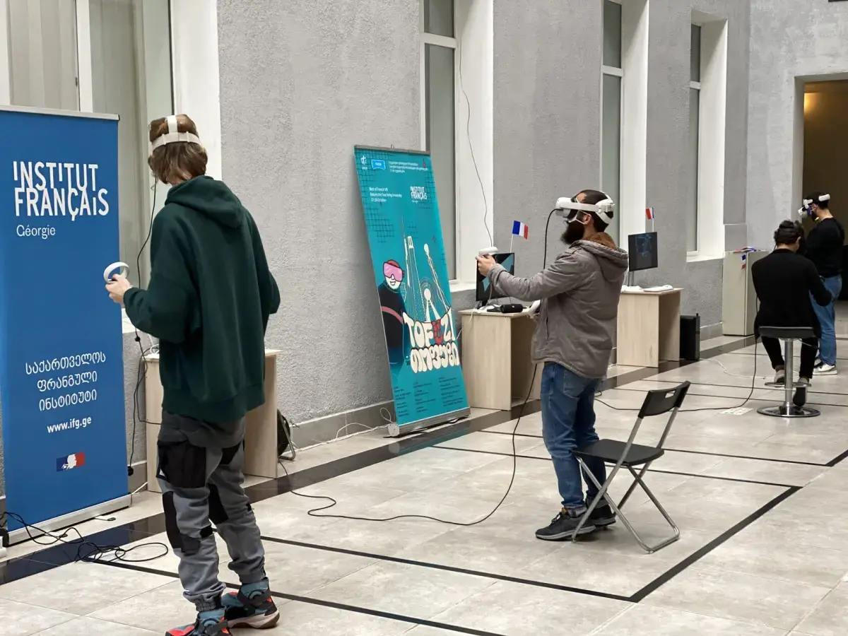 Visitors exploring VR stations across the university atrium