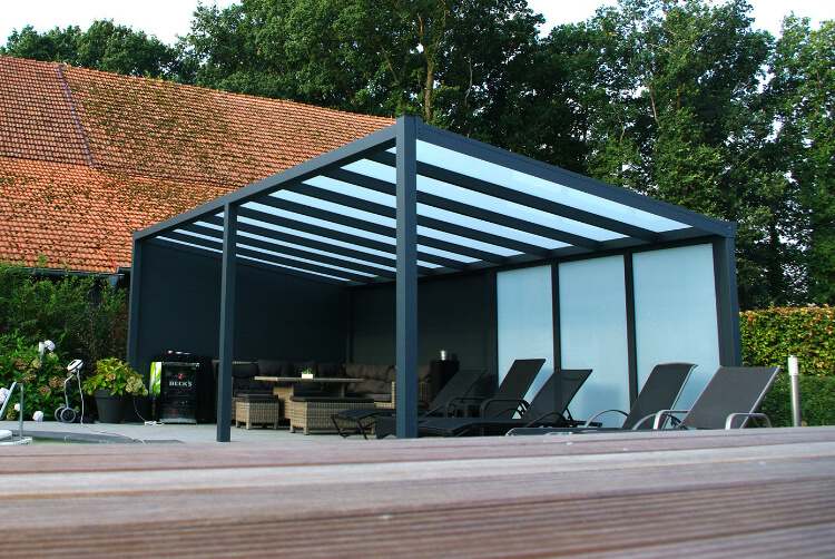 Eine Terrassenüberdachung aus Aluminium und Glas neben einem Pool, ein Gaubendach ist im Hintergrund zu sehen