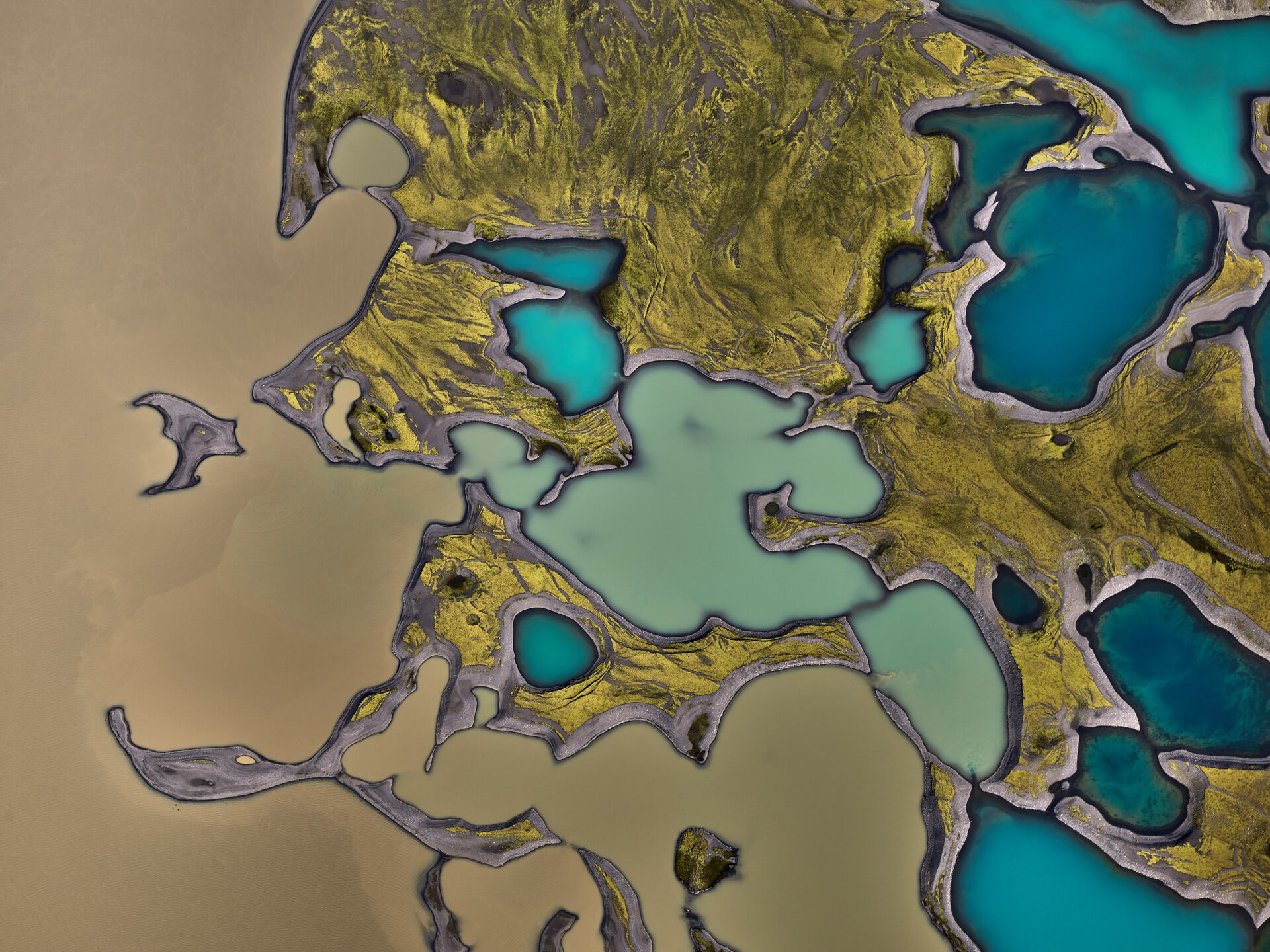 Photo portal: turquoise lakes in a moss-covered lava field, from above