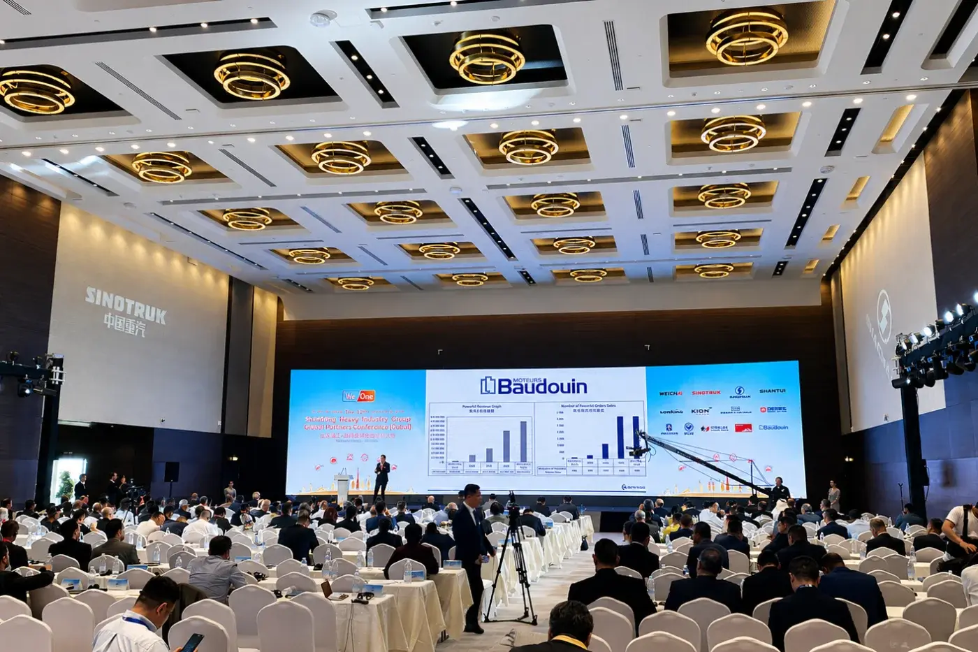 Conference room with presentation screens, stage and banquet seating