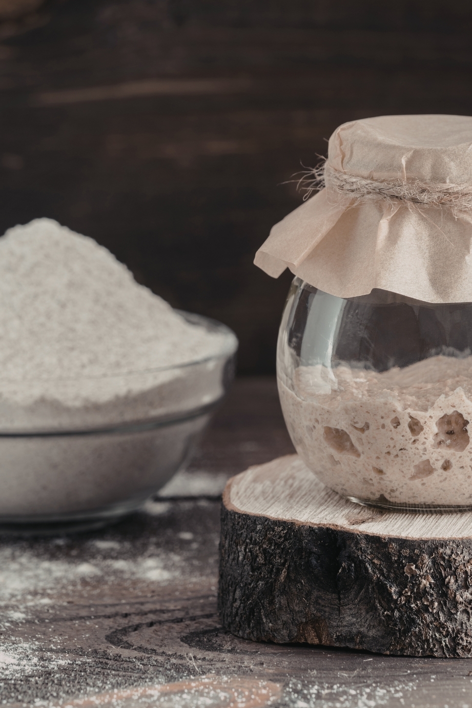 Active sourdough starter with bubbles and strong rise in a glass jar
