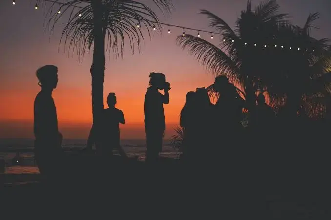 A group of friends enjoying a beautiful sunset together, setting the perfect vibe for a pre party in Canggu.