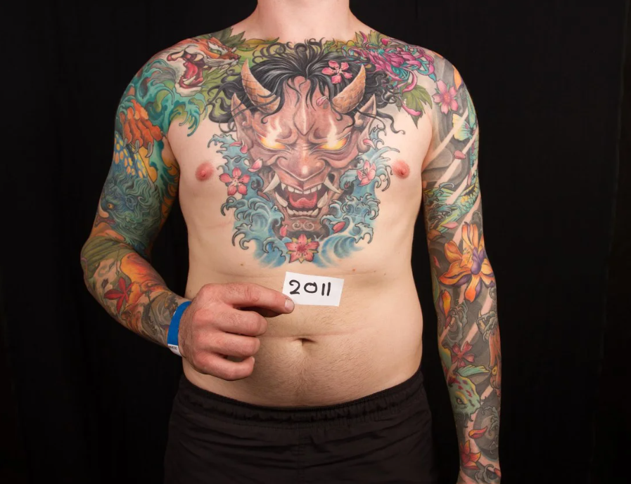 Large-scale Japanese style bodysuit tattoo featuring a Hannya mask on the chest, waves, and cherry blossoms, by Rinat Mingazdinov, Los Angeles, West Hollywood