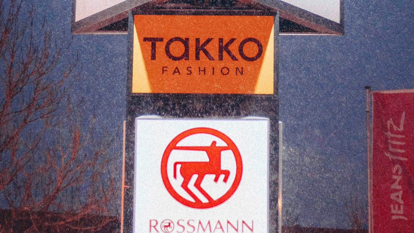 Retail park signs for Action, Takko Fashion and Rossmann