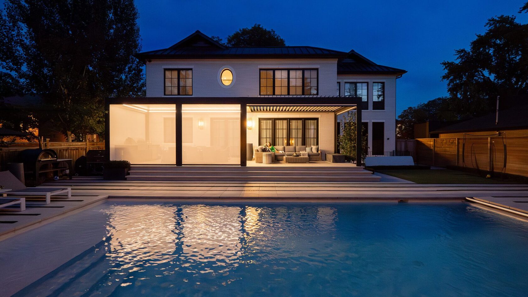 Luxury aluminum pergola with integrated lighting by a pool
