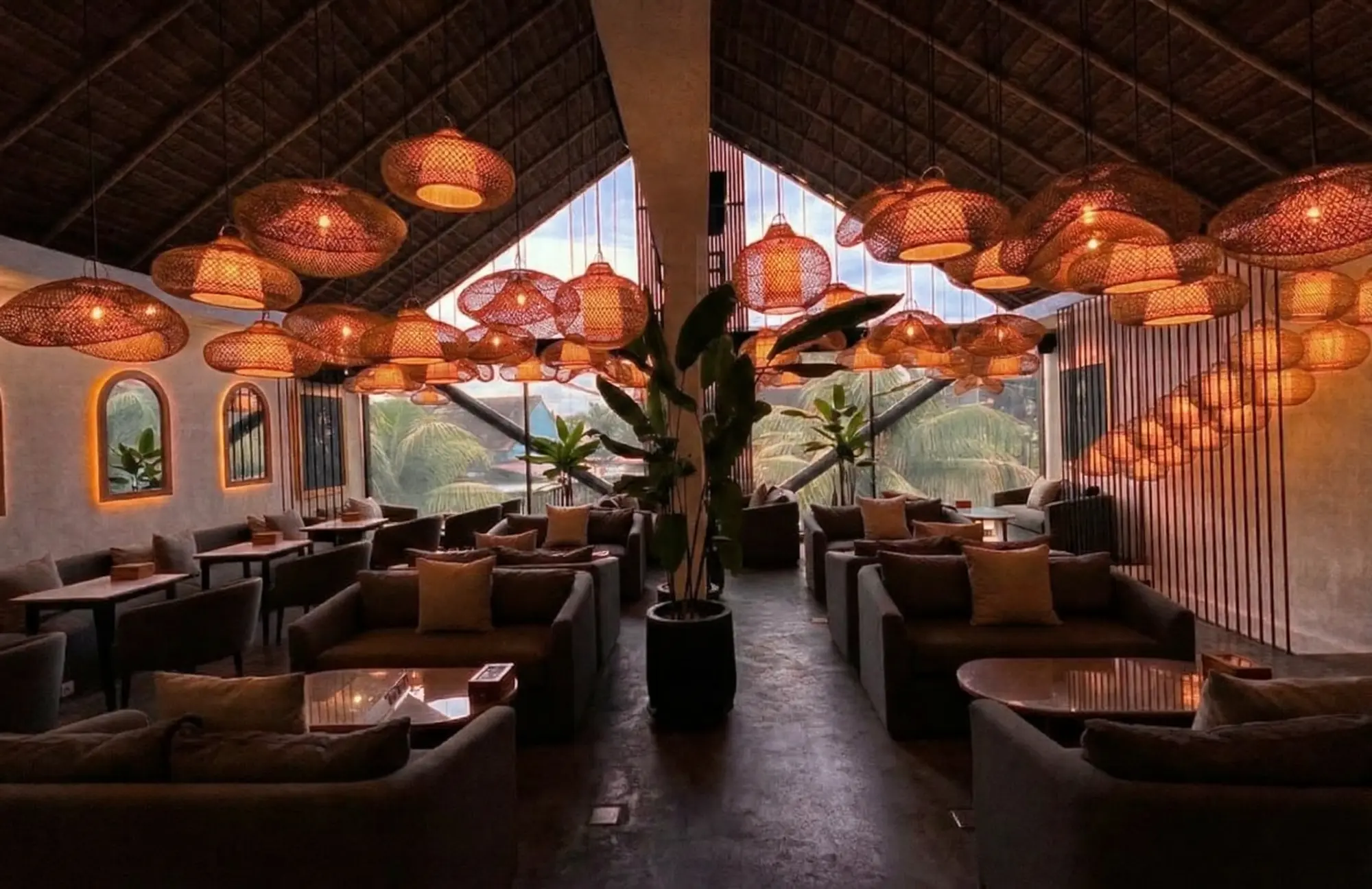 Tropical industrial interior with hanging lamps at Eden Lounge Canggu, a perfect spot for a shisha date.