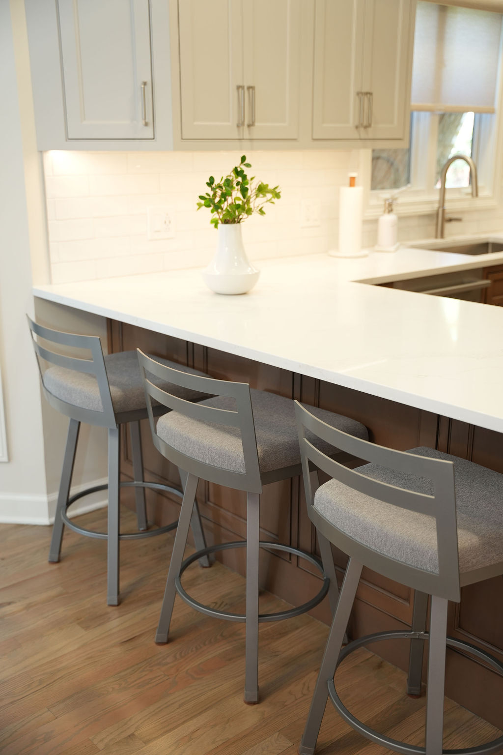 Quartz countertop island with seating in a remodeled family kitchen