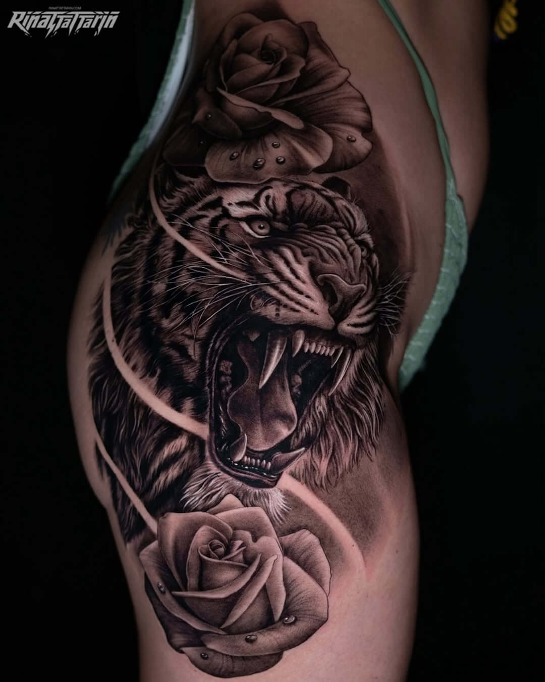 tattoo on a woman's thigh, tiger and roses