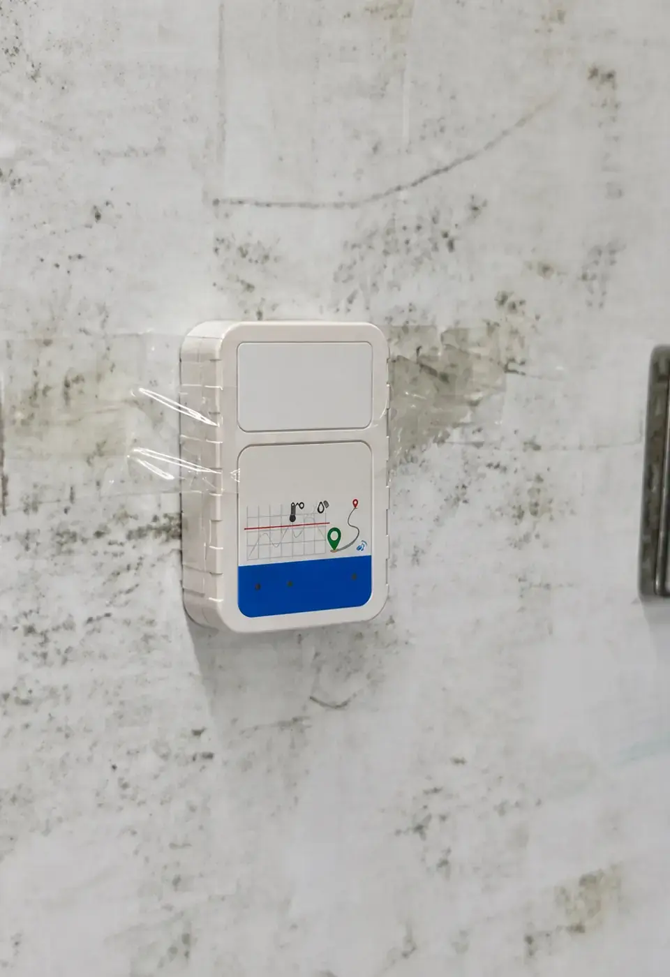 Data logger installed on the wall inside refrigerated transport