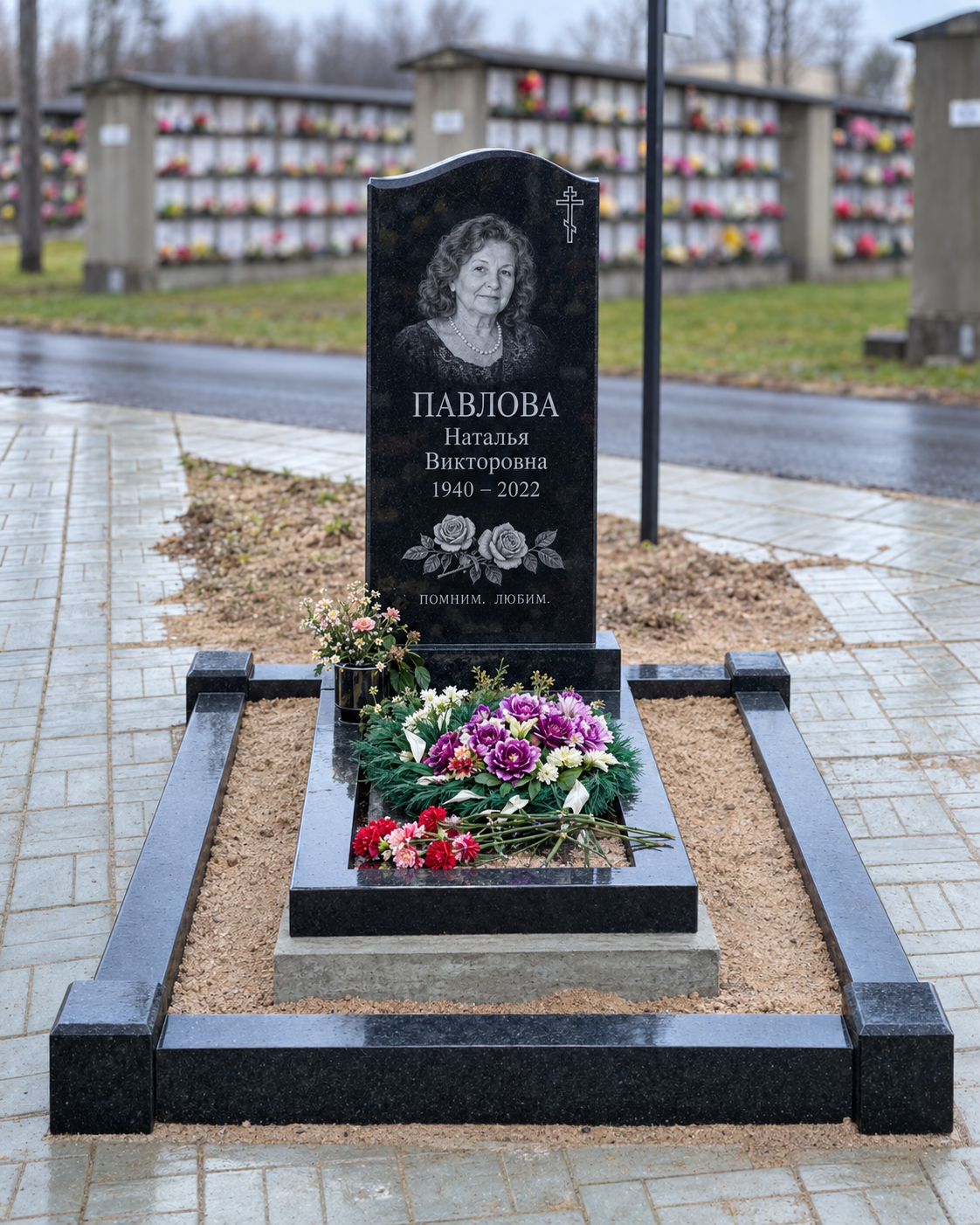 Стела с цветником и бордюром после установки на участке. Имена, даты и портреты изменены.