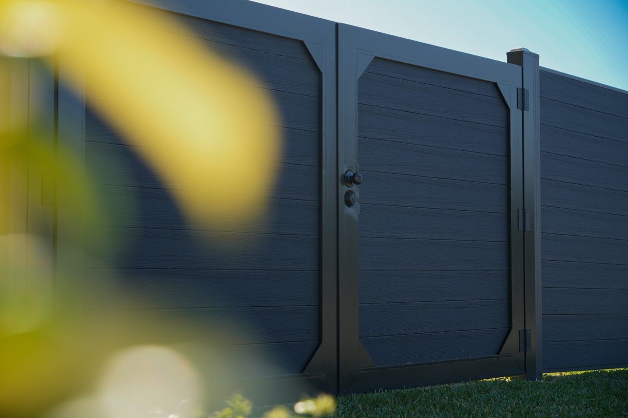 Modern WPC fence and gate system in a finished yard
