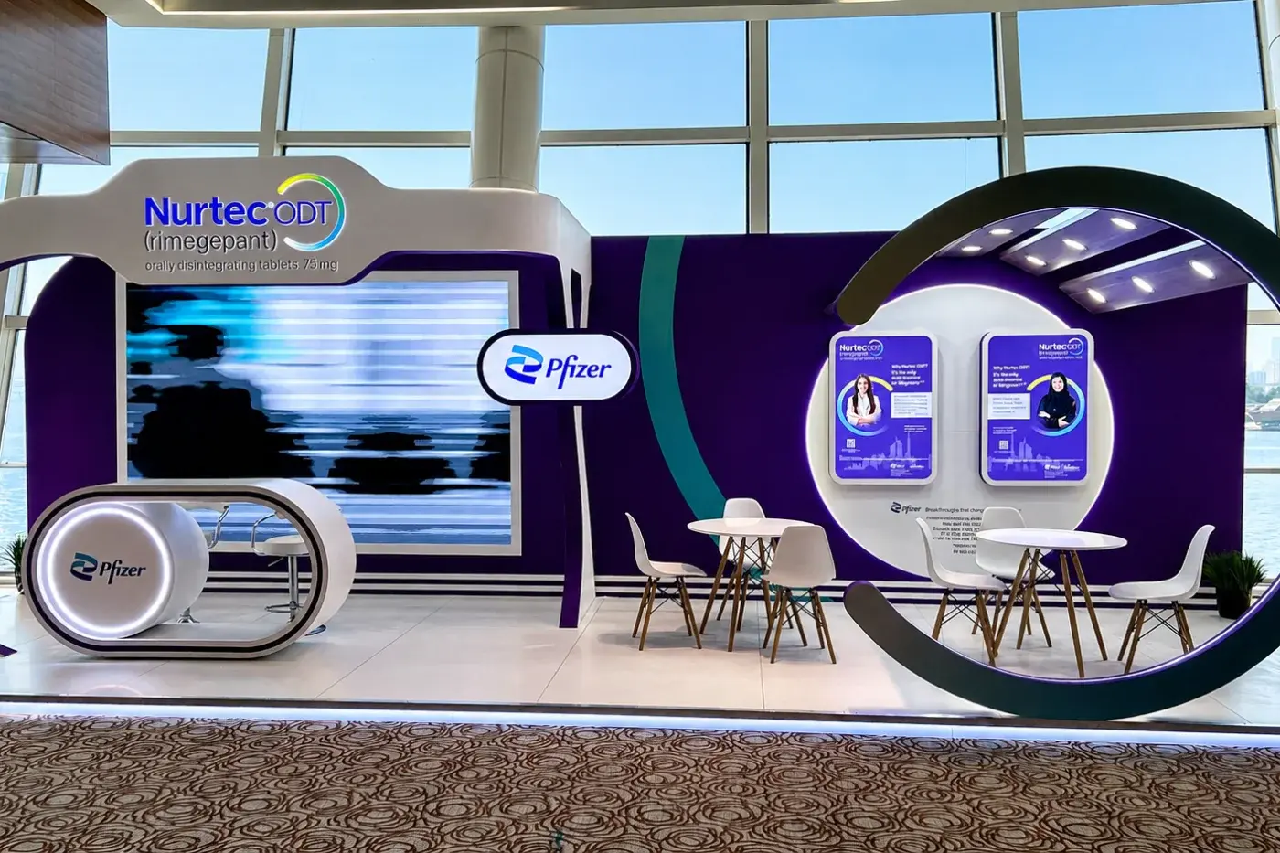Exhibition stand with a circular LED feature and demonstration counters