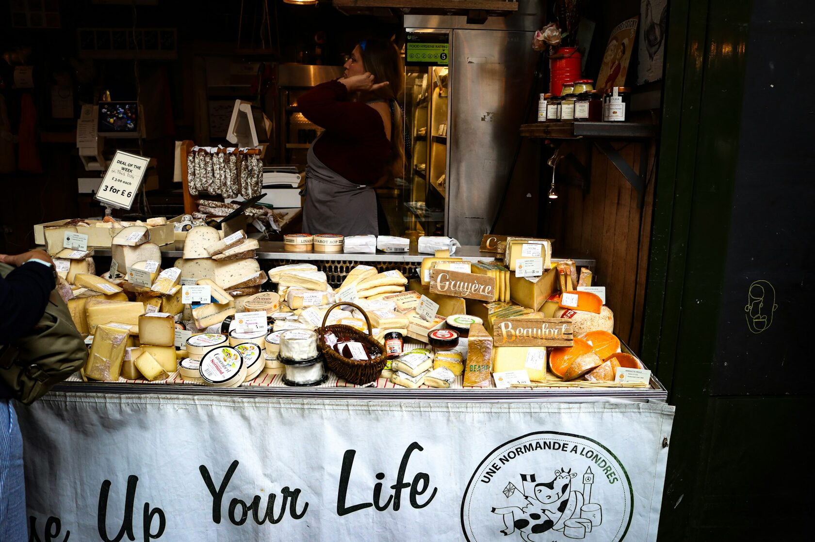 Artisanal Normandy cheese and local produce arranged on a rustic table
