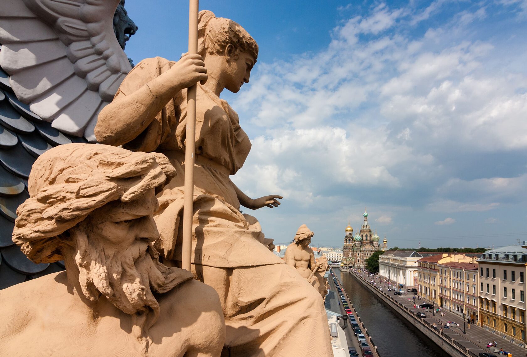 sculptures on the roofs of saint petersburg and the canal