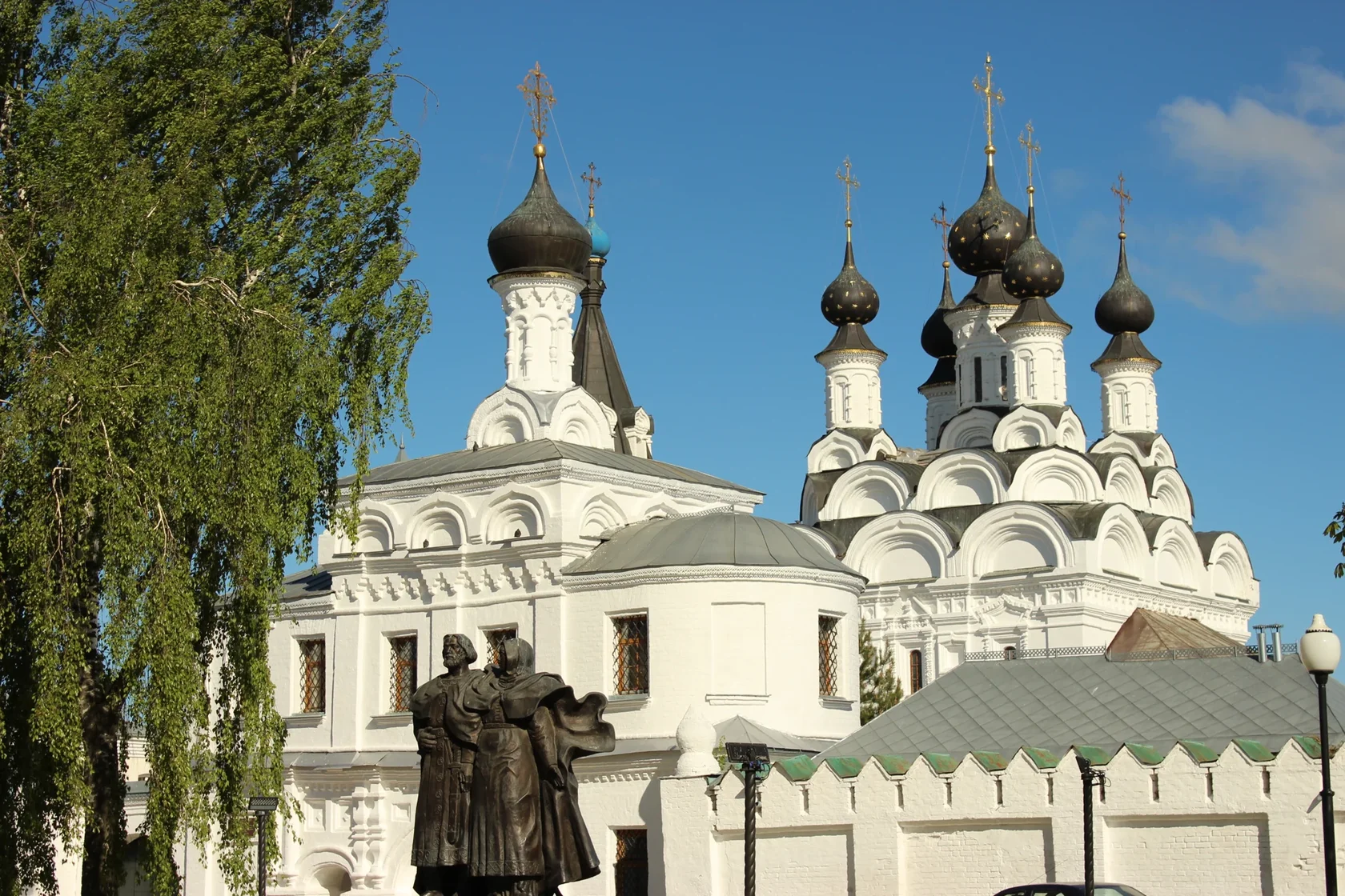 Памятник Петру и Февронии на фоне Благовещенского монастыря в Муроме
