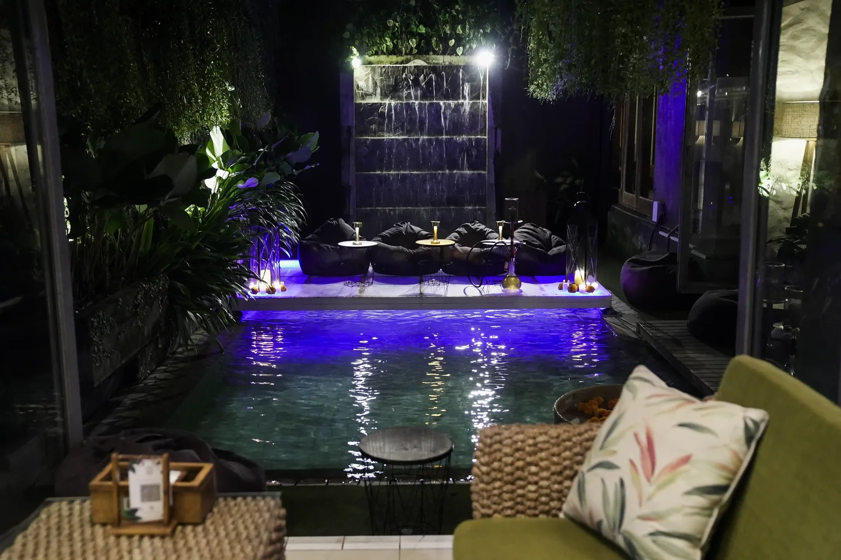 Nighttime view of the open-air poolside lounge and comfortable seating at Eden Park, highlighting the best places to watch FIFA World Cup 2026 in Bali.