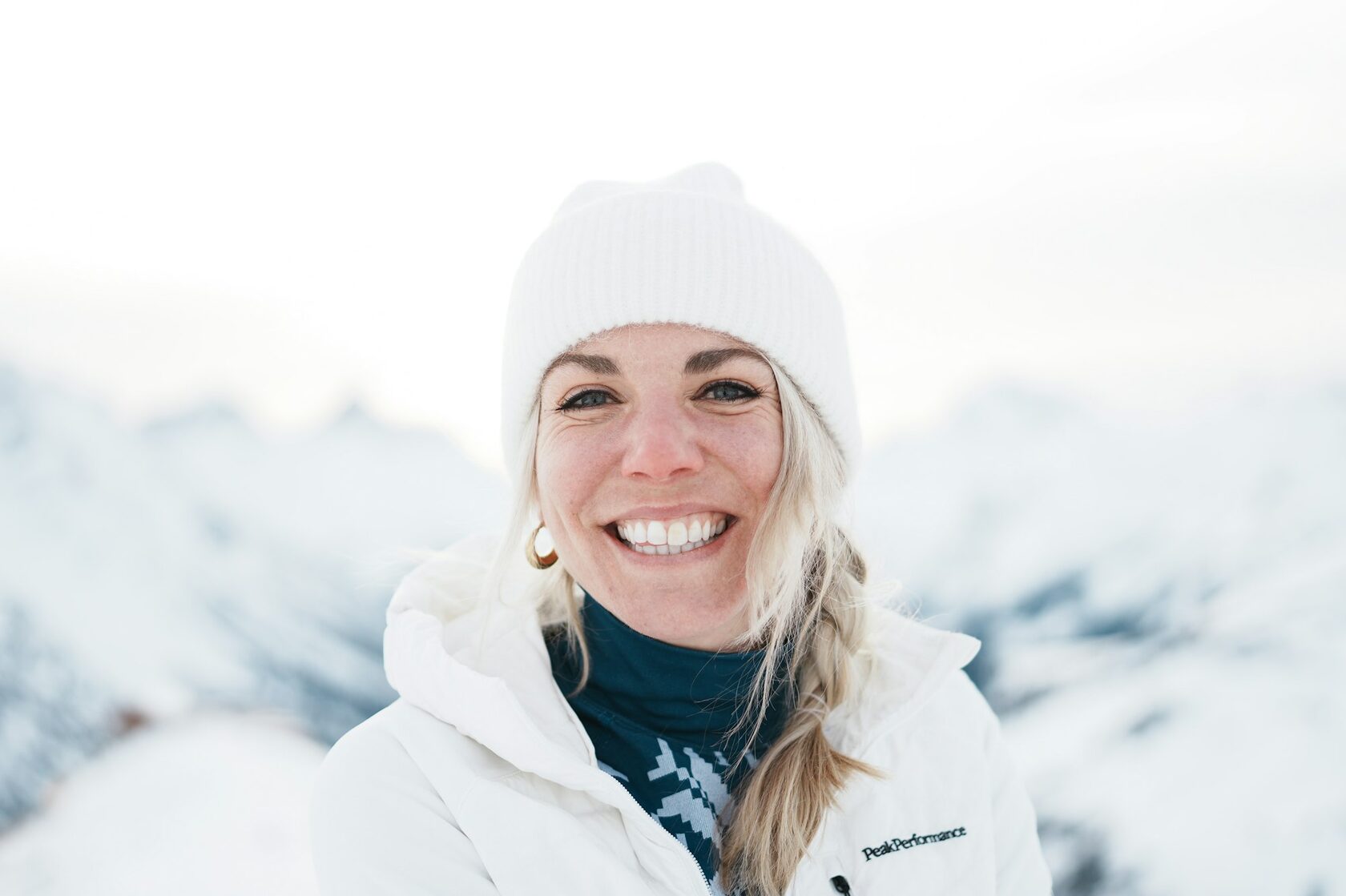 Nunu — model in white puffer jacket in snowy mountains