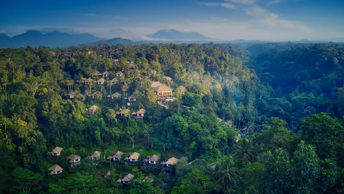 An aerial view of Ubud's vibrant green jungle, tiered valleys, and wellness resorts, showcasing the natural environment that surrounds the best spa in Ubud.