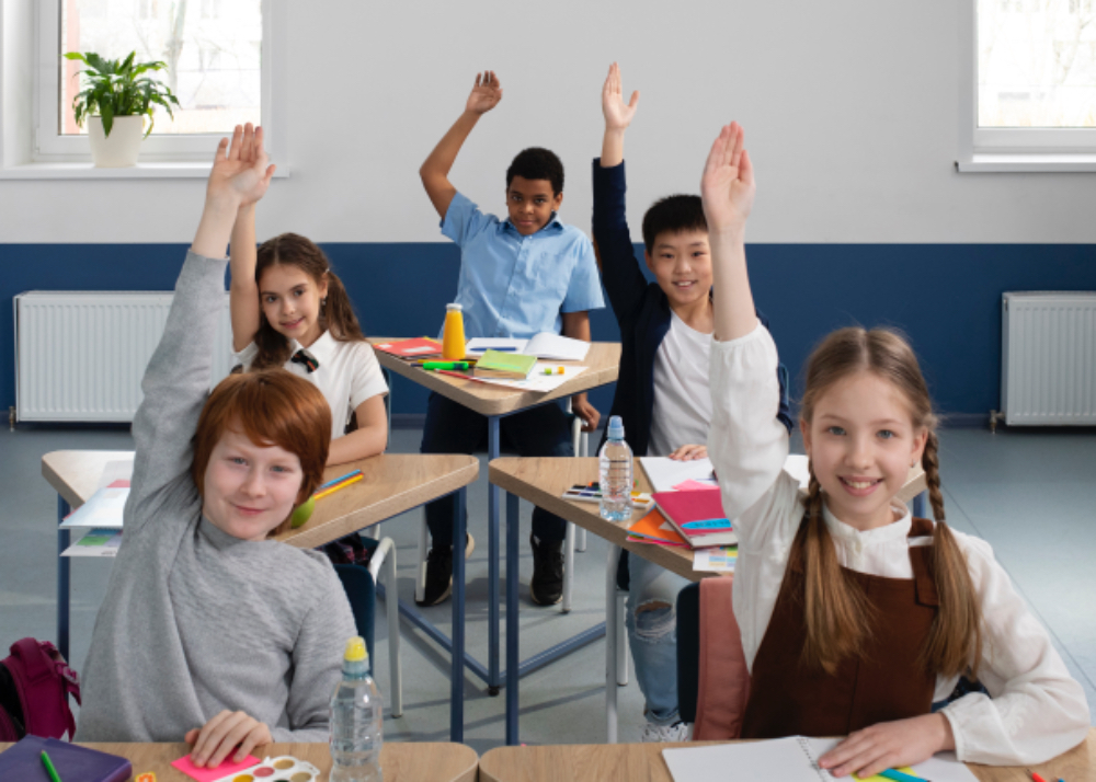 Children raise their hands during the lesson.