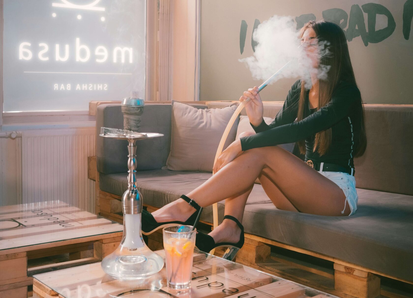 a woman enjoy Hookah in living Room