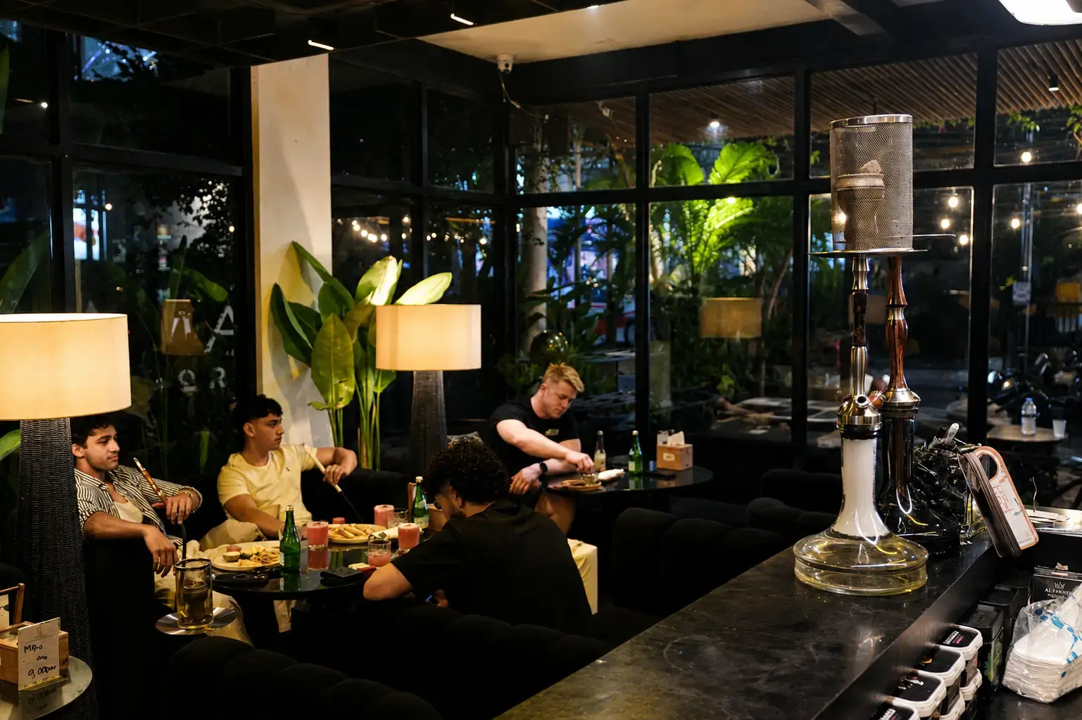 Guests relaxing with drinks and premium shisha at Eden Hookah Club an ideal spot for a pre party in Canggu.