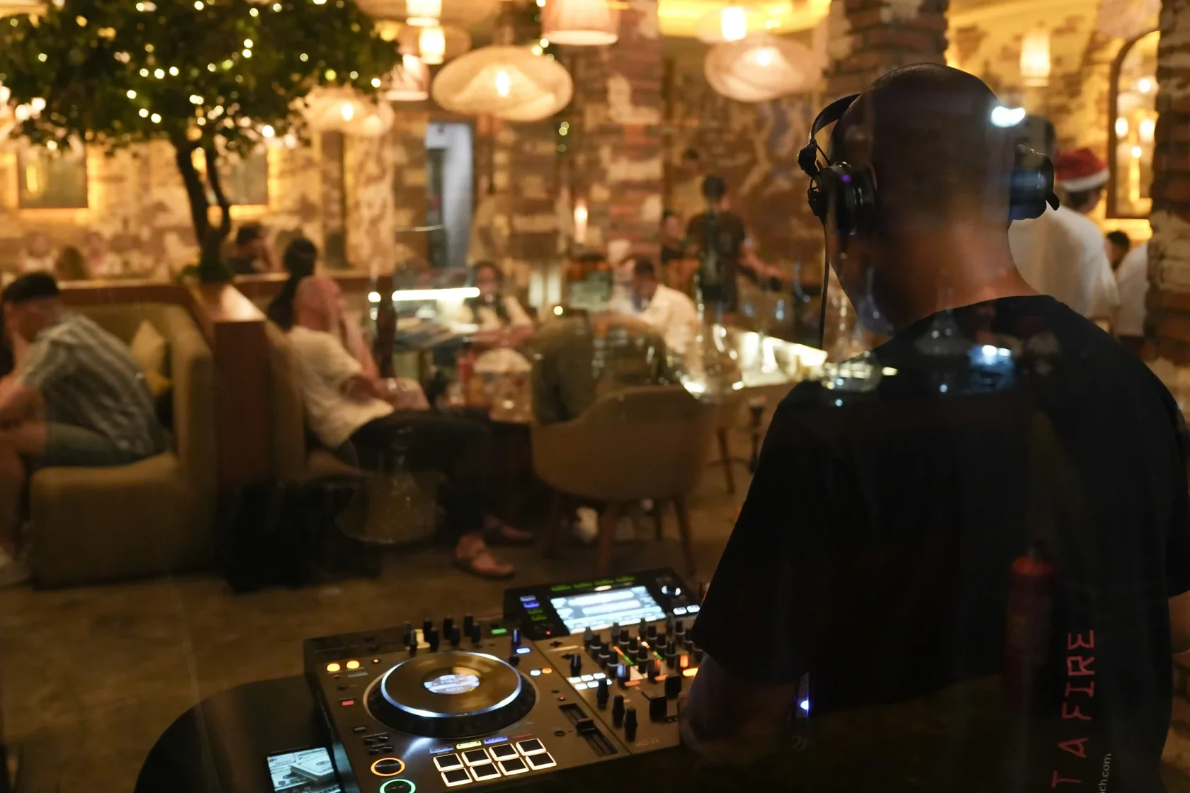 A DJ spinning tracks at Eden Hookah Club, setting a cool and relaxed vibe for guests hanging out in the lounge.