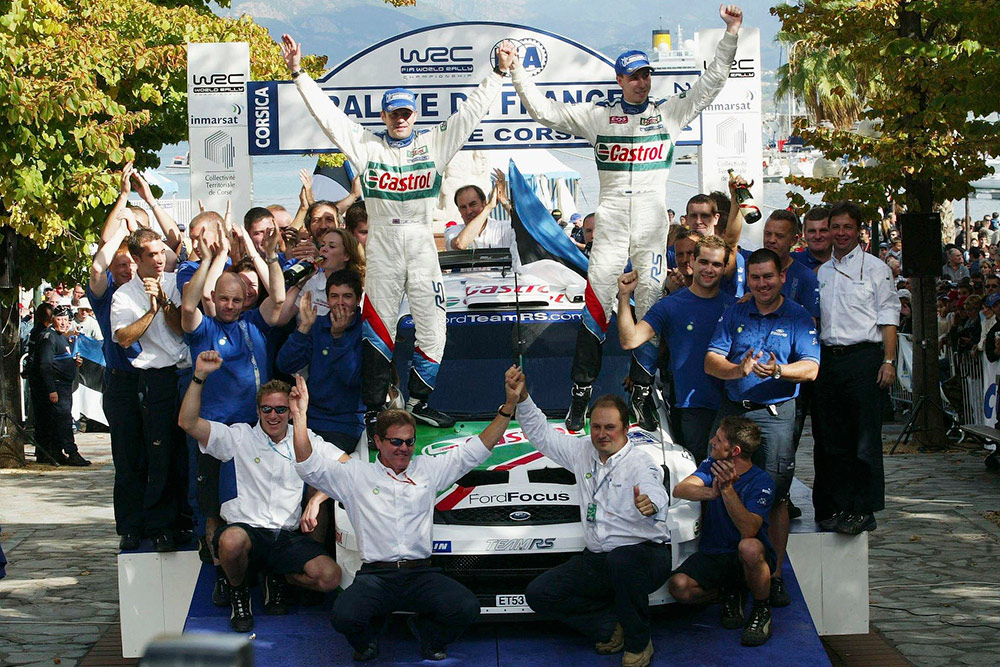 Победители ралли Корсика 2004 Маркко Мяртин и Майкл Парк, Ford Focus RS WRC '04 (ET53 UJP), в окружении команды M-Sport