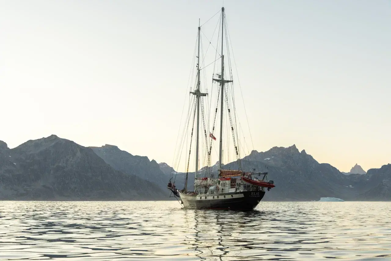 Discover whether a Greenland cruise or a sailing expedition is the best way to explore the Arctic. Compare cruise ships yacht charters sustainable travel remote fjords wildlife encounters and authentic Greenland adventures.