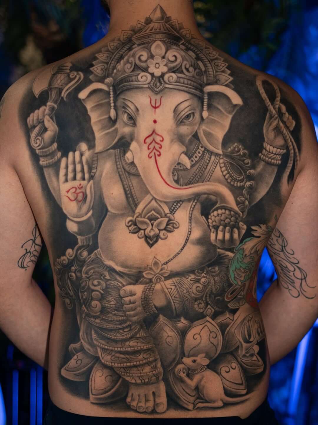 tattoo on the back, Ganesha, son of Shiva and Parvati, man with an elephant head, Hinduism
