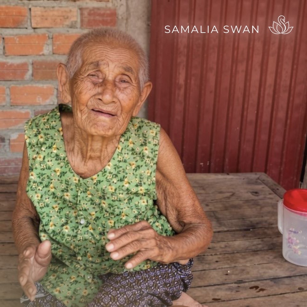 An elderly Cambodian grandmother with a warm, gentle smile