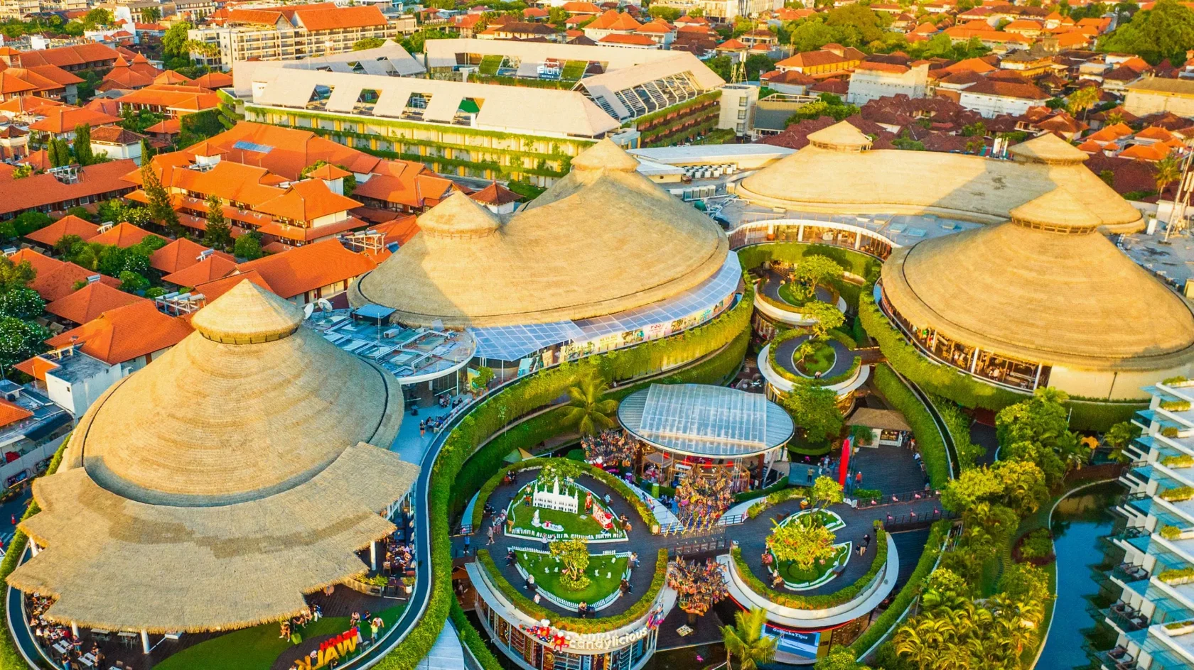 An aerial view of the iconic thatched roofs at Beachwalk Shopping Center, housing a premium public cinema for travelers looking for where to watch a movie in Bali.