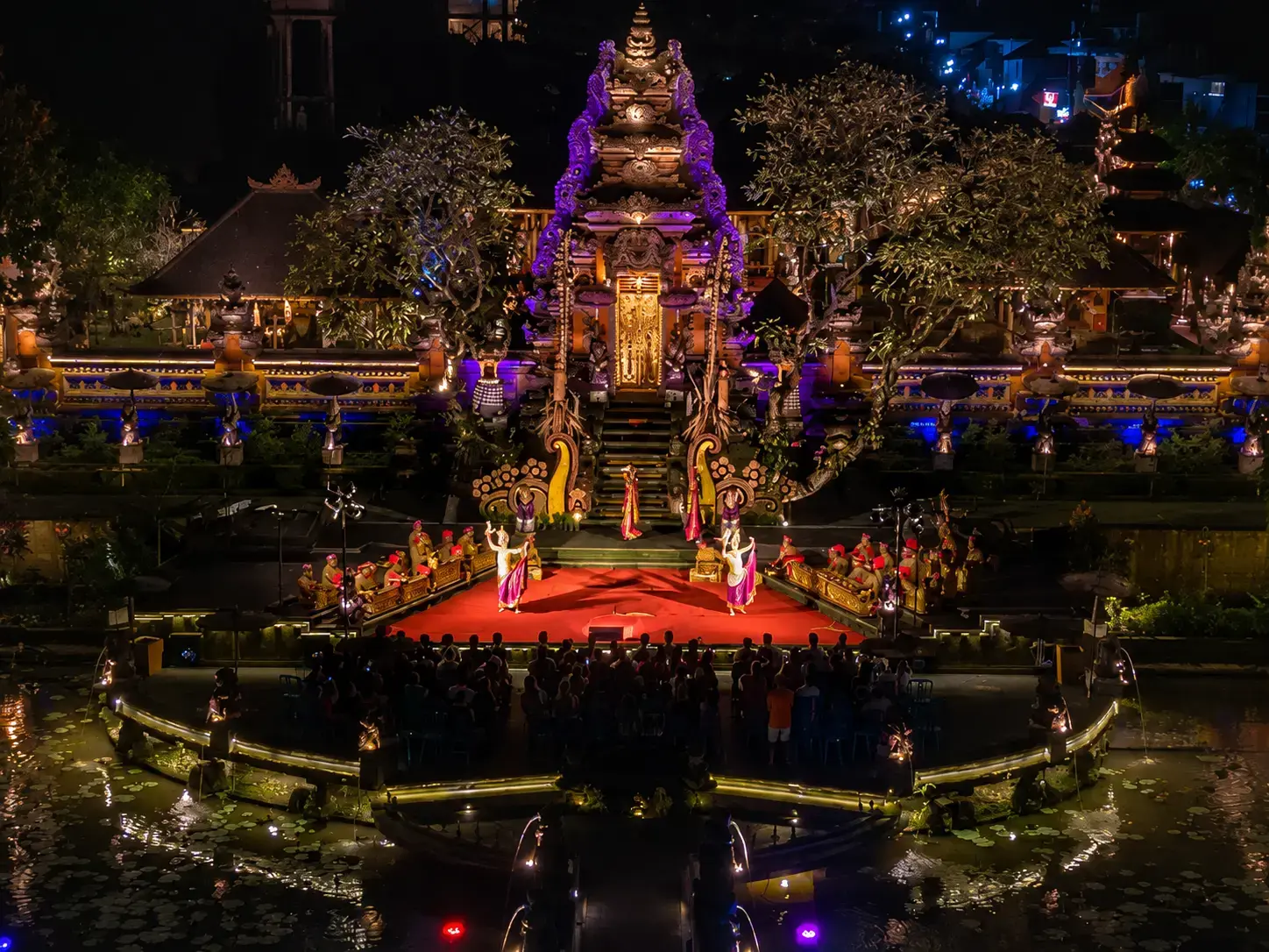 Traditional Balinese dancers performing on an illuminated stage at Ubud Palace, a cultural highlight of what happens in Bali on Wednesday.