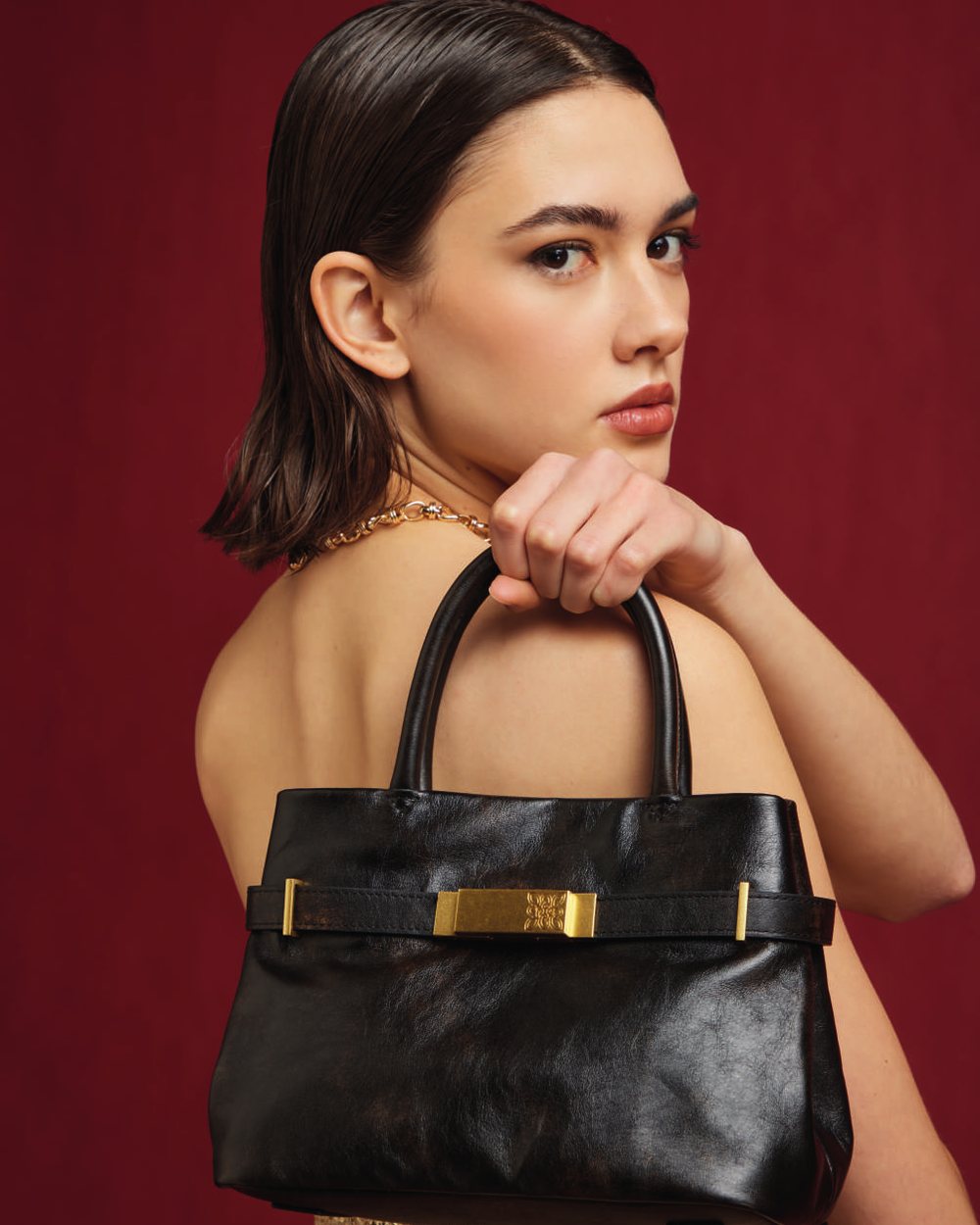 House of Florence Autumn-Winter 2026: black leather handbag with gold detail