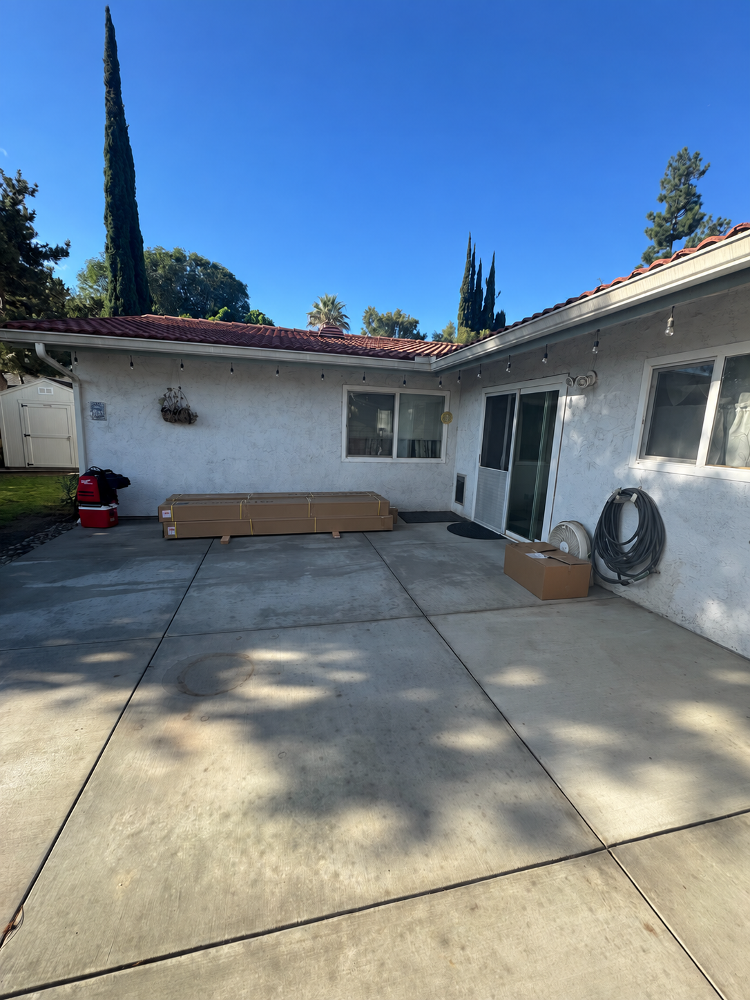 Open concrete patio in Costa Mesa before motorized pergola installation