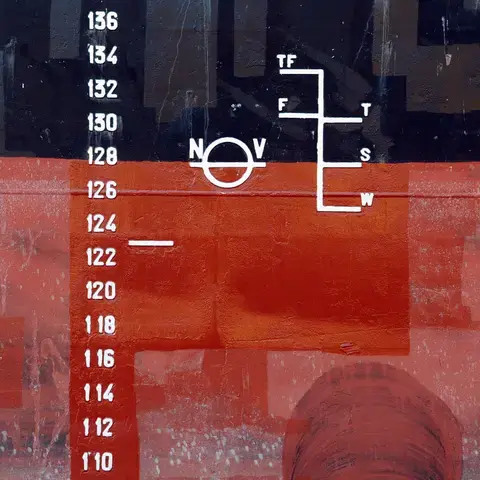 A mark on a ship that indicates the maximum depth to which a ship may sit in the water when fully loaded.