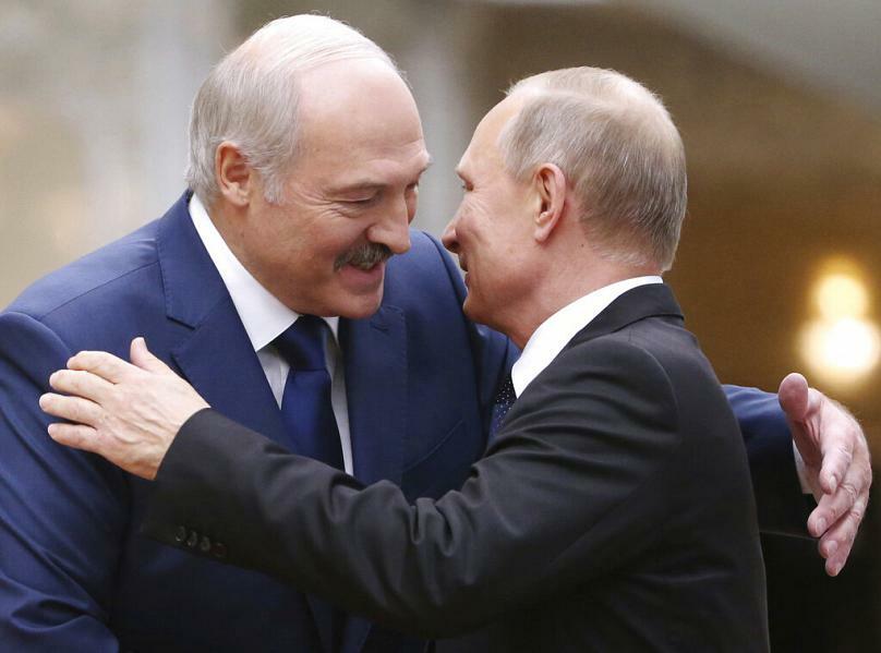 Belarusian President Alexander Lukashenko, left, greets Russian President Vladimir Putin at a security summit in Minsk