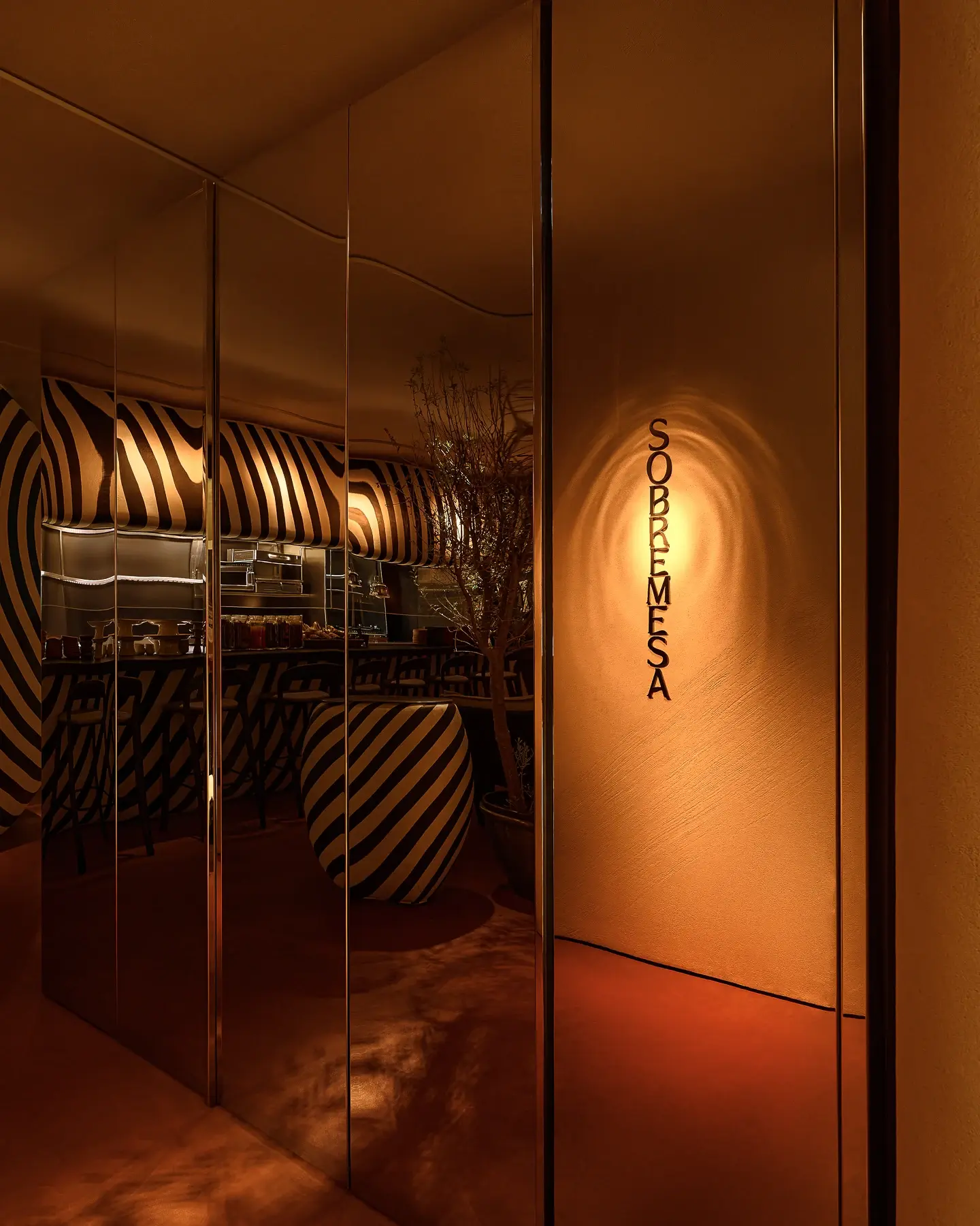 Warmly lit entrance looking into the Sobremesa restaurant