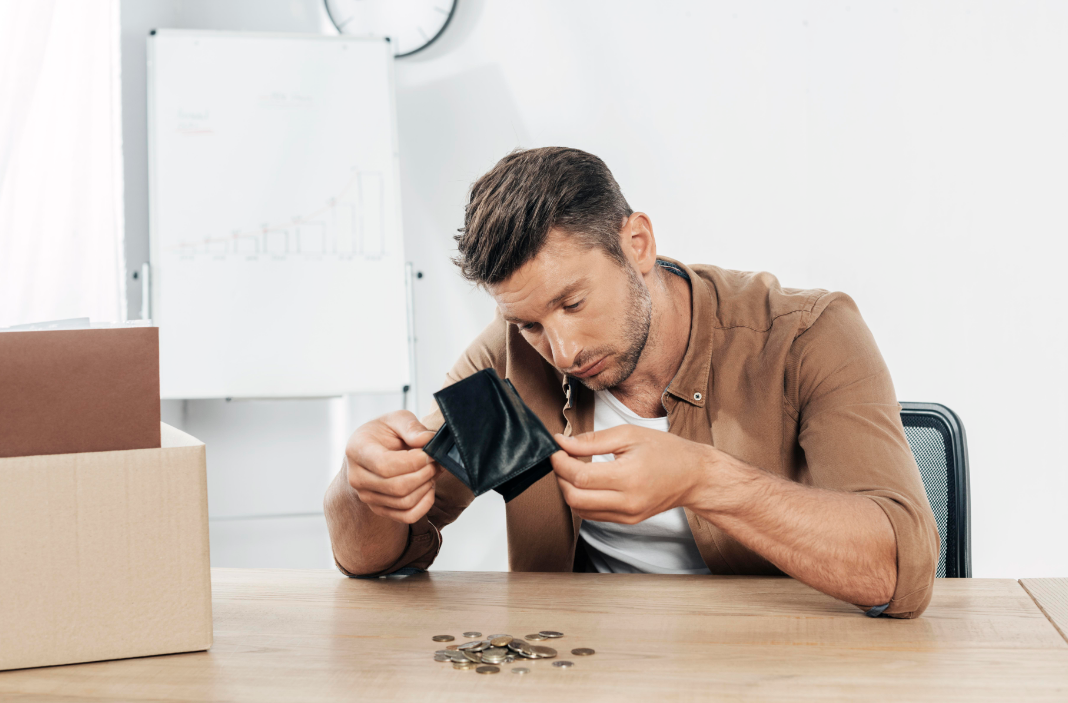 A sad trader counting coins after Binance liquidation