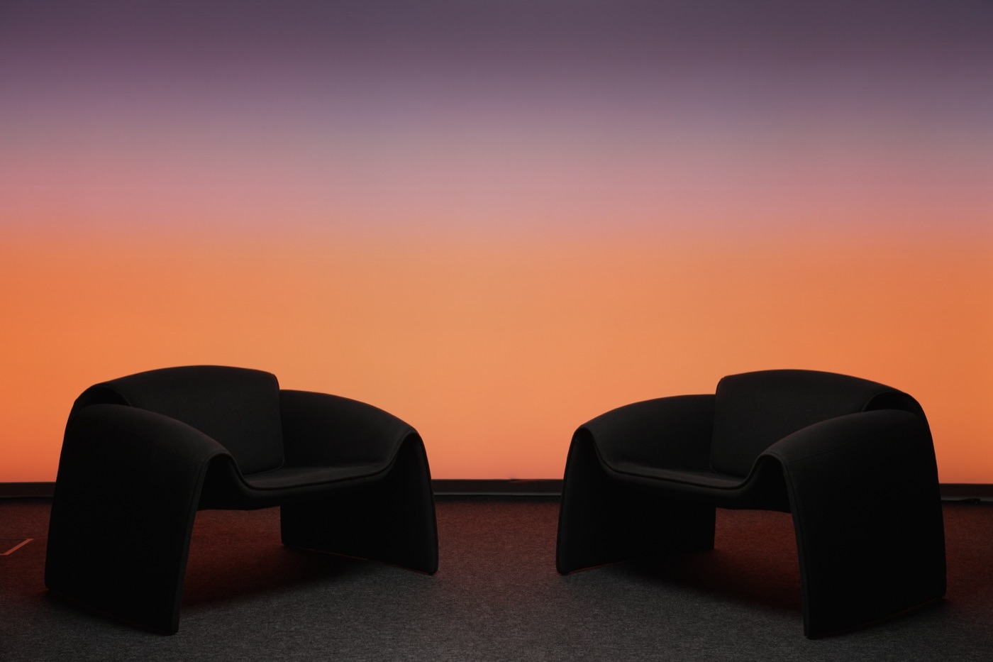 Studio wall lit in a purple-to-orange sunset gradient
