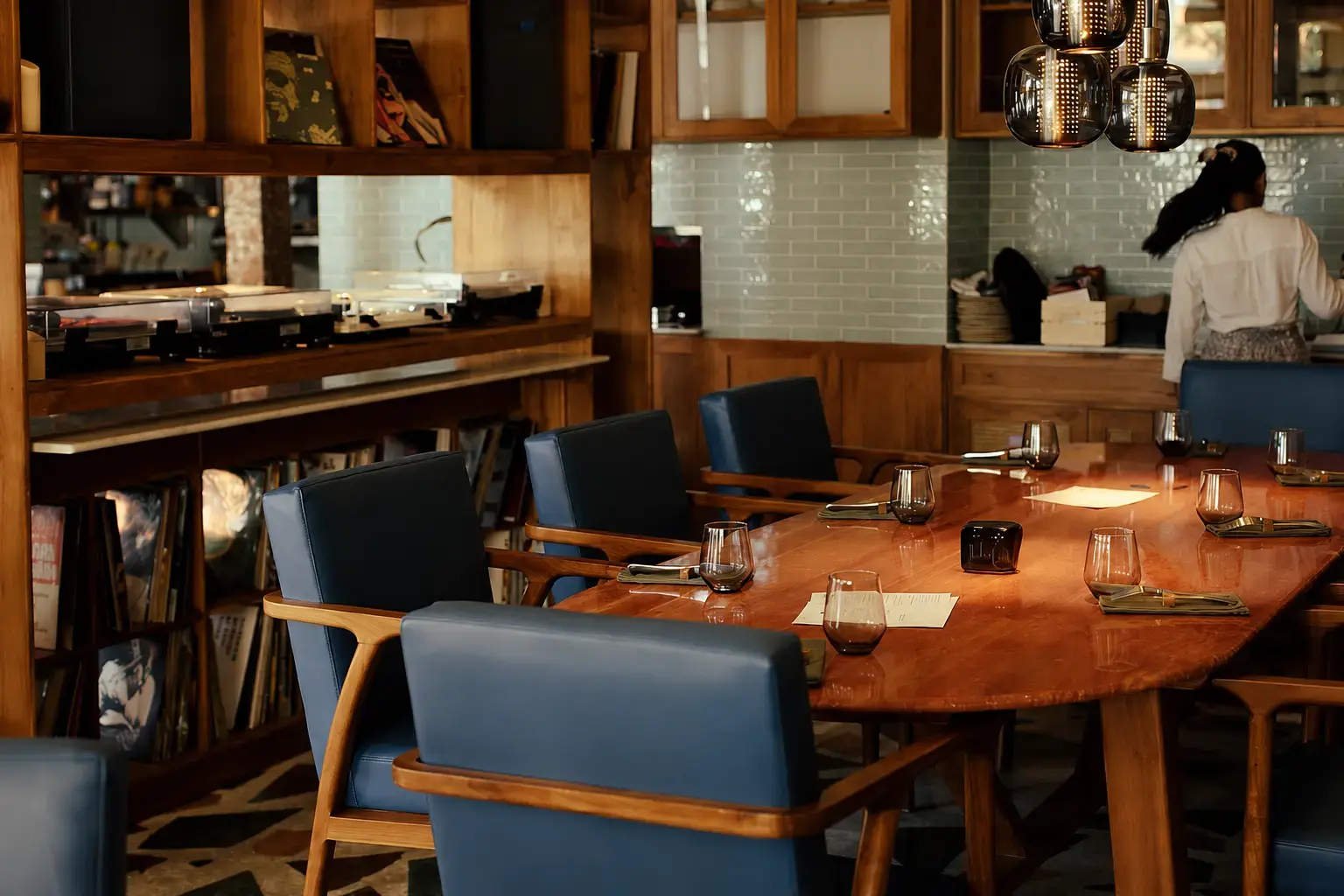 Interior view of Da Me Vini e Vinili, a retro-chic wine bar in Petitenget known for its vinyl records, communal table, and as a great spot for date night in Seminyak, where you can find delicious pasta.