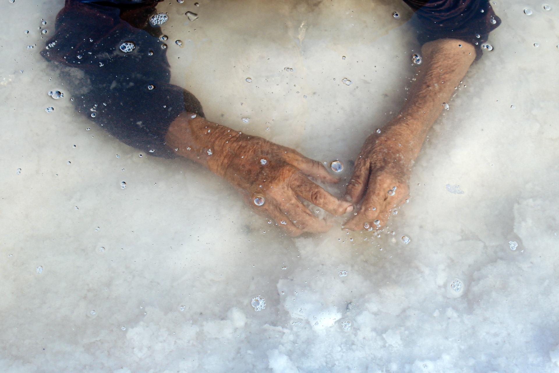  Iran | Solmaz Daryani The hands of the photographer’s grandmother during a ritual bath in the hypersaline waters of what remains of Lake Urmia