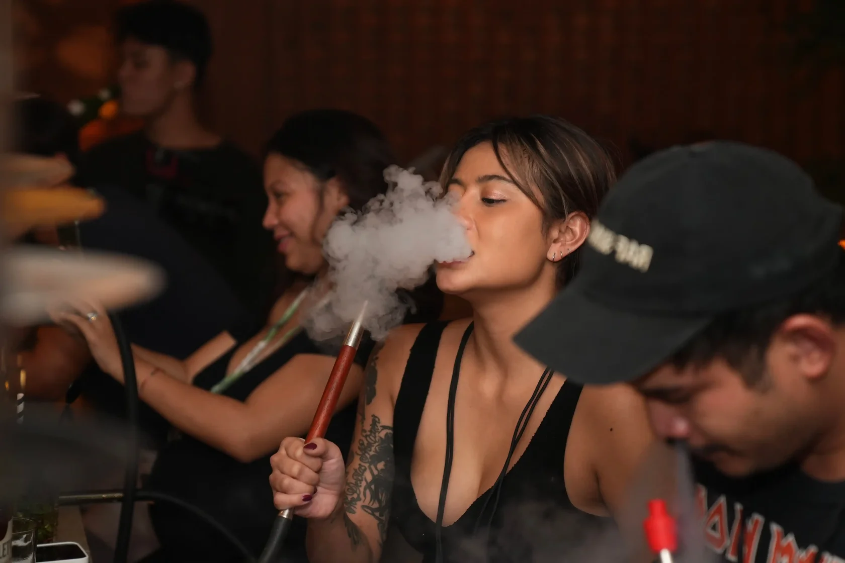 Guests enjoying a relaxed shisha session in Bali while sharing a hookah