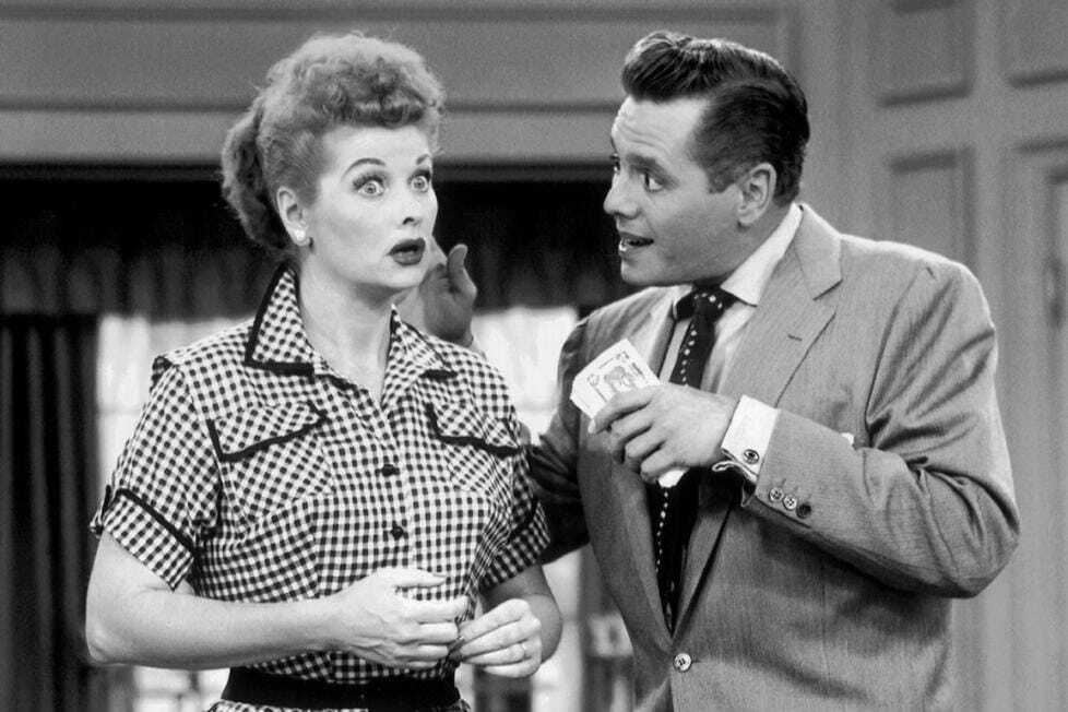 I Love Lucy: Lucy's eyes go wide with surprise/shock as Ricky talks to her while holding a handful of money.