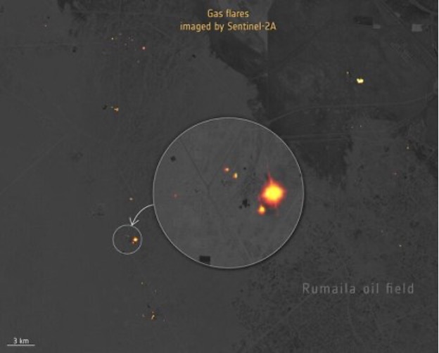 Nighttime imagery of oil fields in Iraq, with gas flares showing up as orange glows on the grey background